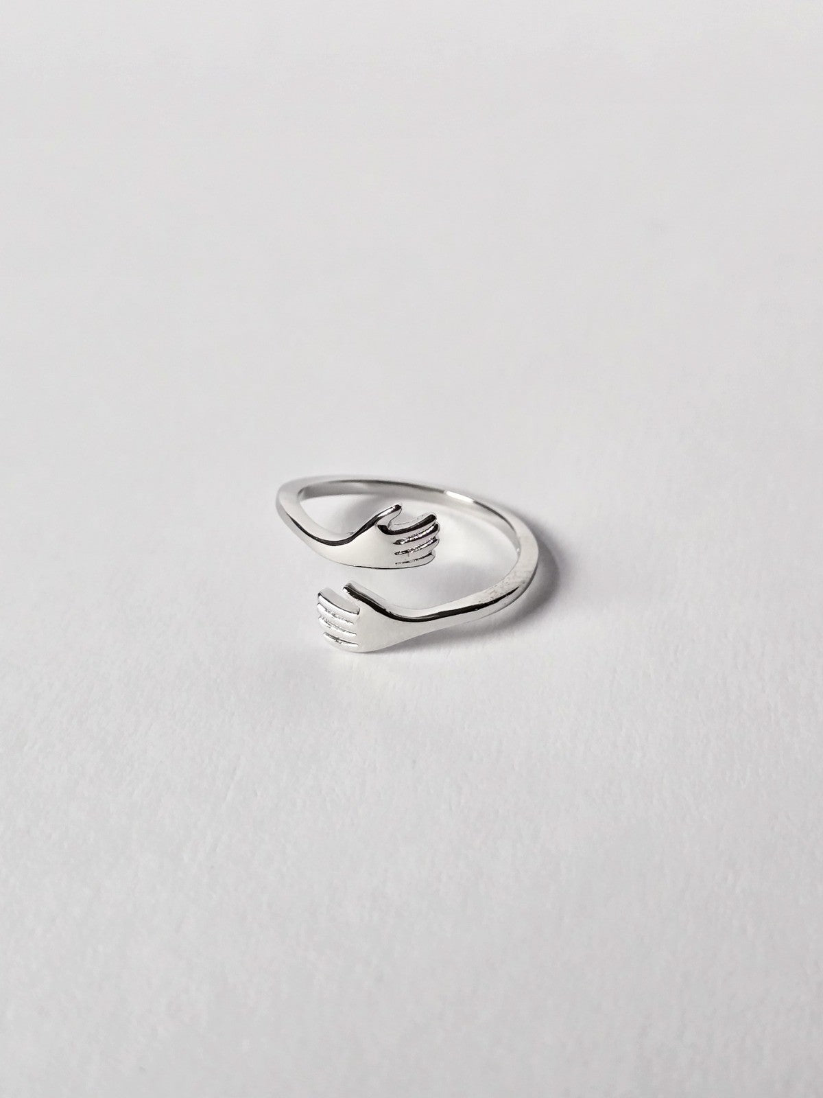 Silver ring with a unique design on a light gray background