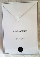 White opal Africa cut out on a sterling silver chain displayed on a white product backing card with the words "a little Africa in my heart" in black text