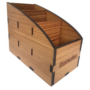 Wooden laser cut remote box with three compartments and the word "remotes" laser etched on the front.