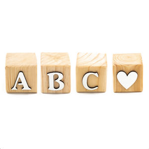 four single wooden letter blocks in a row displaying the letters a, b, c and a heart shape