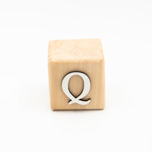 Wooden alphabet letter block Q.