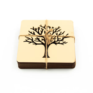 stack of six beige wood coasters with a laser cut tree of life motif.