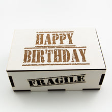 White, rectangular wooden laser cut box with the words: "happy birthday" etched on the lid and the word "fragile" etched on the front.