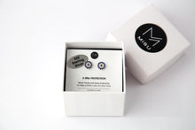 Sterling silver evil eye protection stud earrings in a gift box.