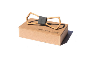 Wooden hand carved bowtie with grey cloth accent piece on top of a wood gift box