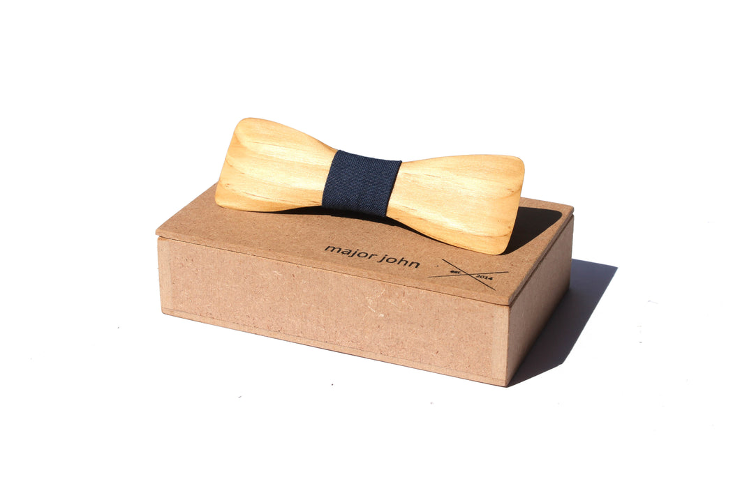 Wooden hand carved bowtie with blue cloth accent piece on top of a wood gift box