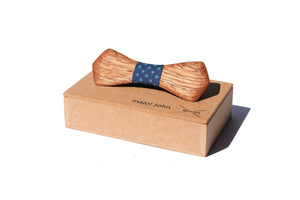 Wooden hand carved bowtie with shwe shwe cloth accent piece on top of a wood gift box